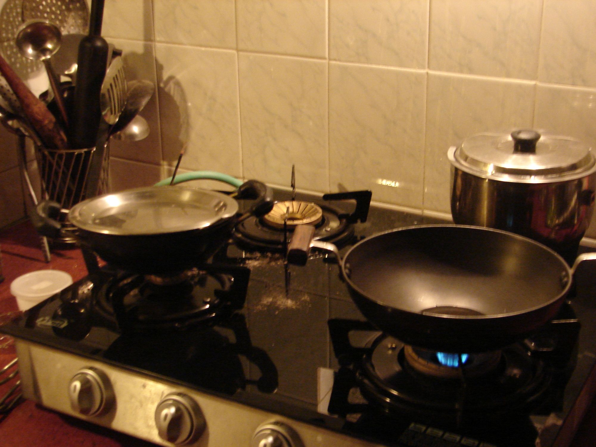 A frying pan on a stovetop with food being cooked in it, seen from above.